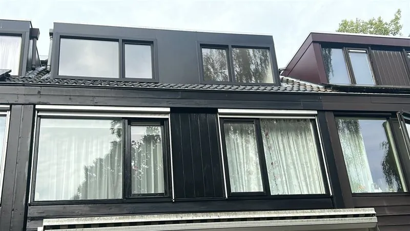 Zwarte dakkapellen op een rij woningen